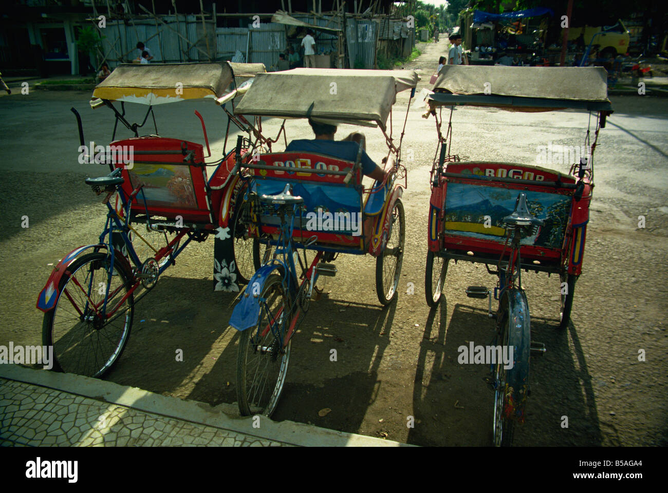 Parked becaks (trishaws), Bogor, West Java, Indonesia, Southeast Asia Stock Photo