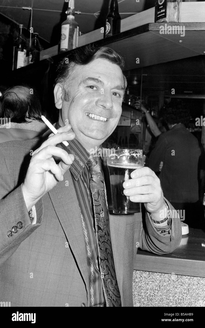 Andy Bradley enjoying his pint and a fag in the local before the chancellor puts up the tax on alcohol and tobacco in the budget. April 1975 Stock Photo