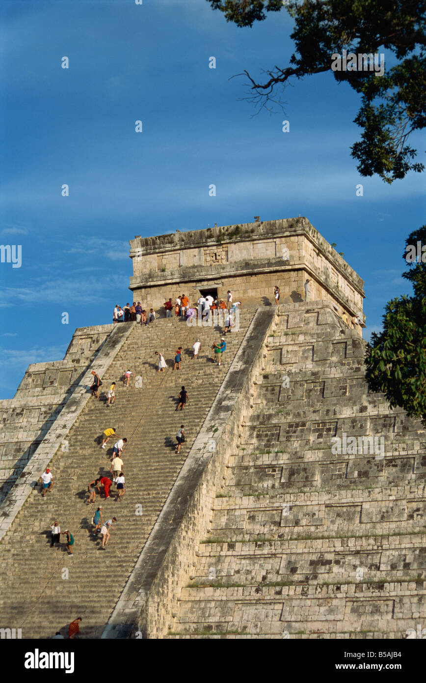 Tourists climbing El Castillo, pyramid dedicated to the god Kukulcan
