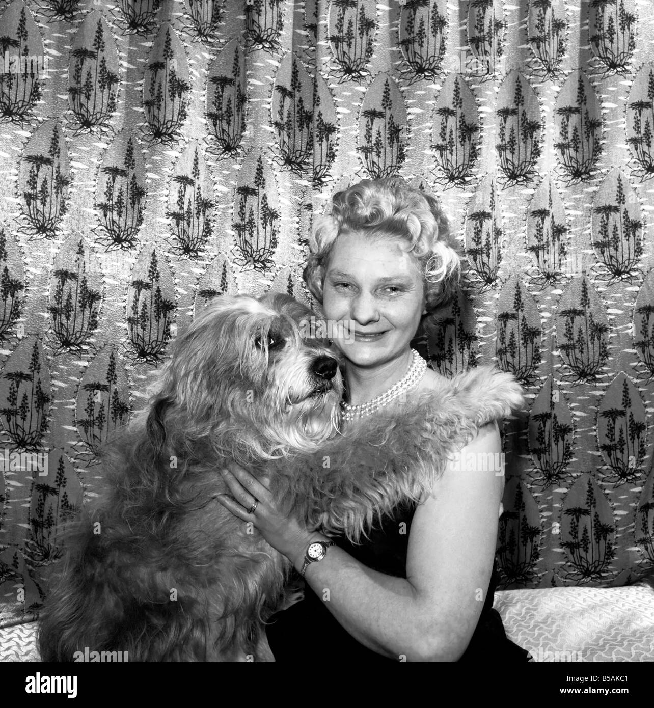 Woman showing affection to her pet dog: 1957 Stock Photo - Alamy