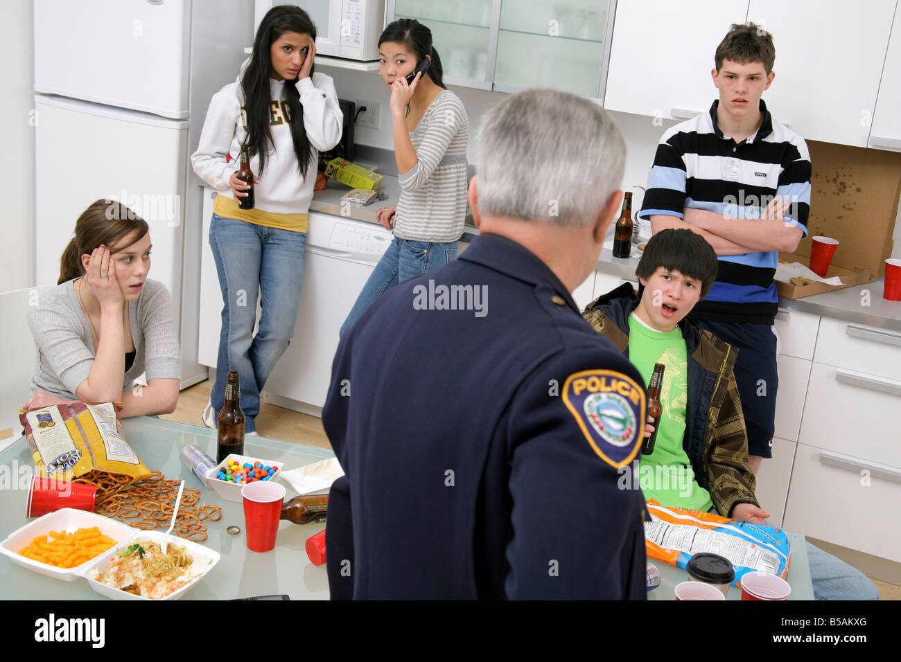 Police officer breaking up an underage party Stock Photo Alamy