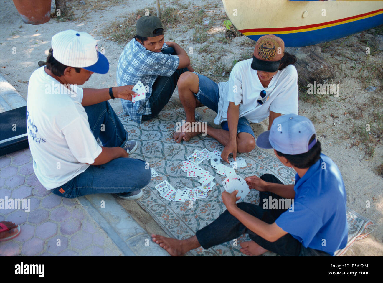 Locals playing cards, Bali, Indonesia, Southeast Asia Stock Photo