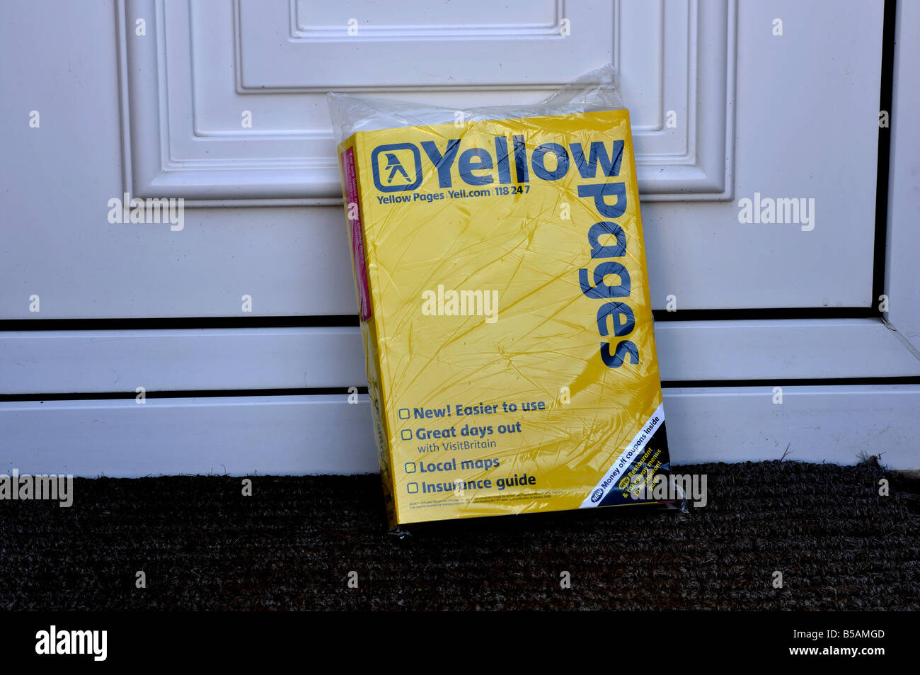 Yellow Pages on front doorstep of house UK Stock Photo