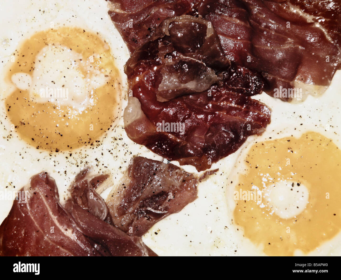 Two Eggs And Bacon In Frying Pan Stock Photo