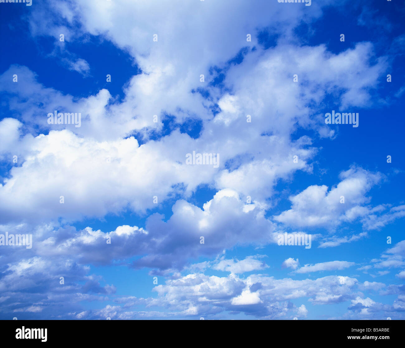 Cloudscape of puffy white clouds in a blue sky Stock Photo - Alamy