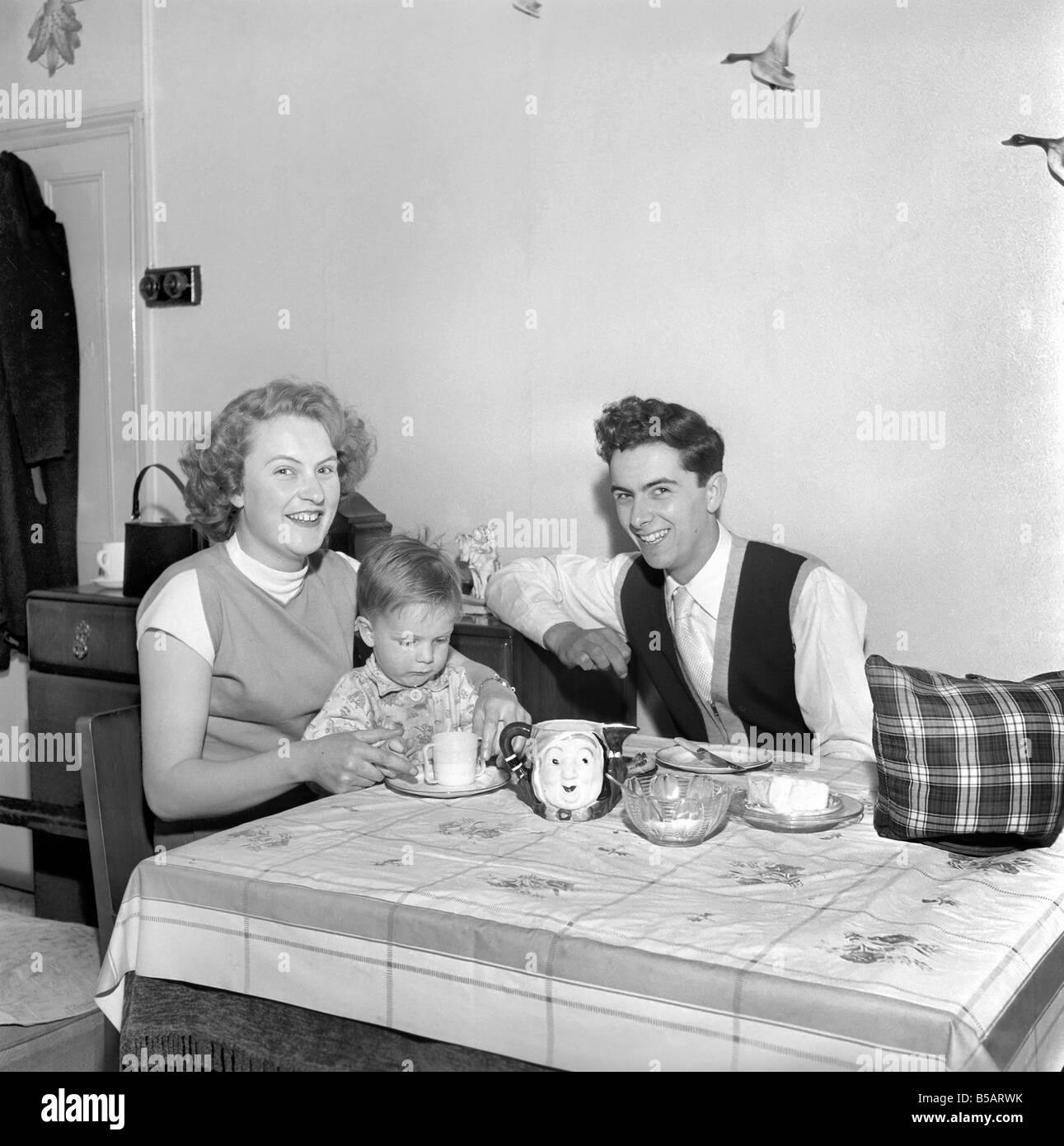 Family life: Mr. and Mrs. Hull giving their son his tea. 1954 A160-002 Stock Photo