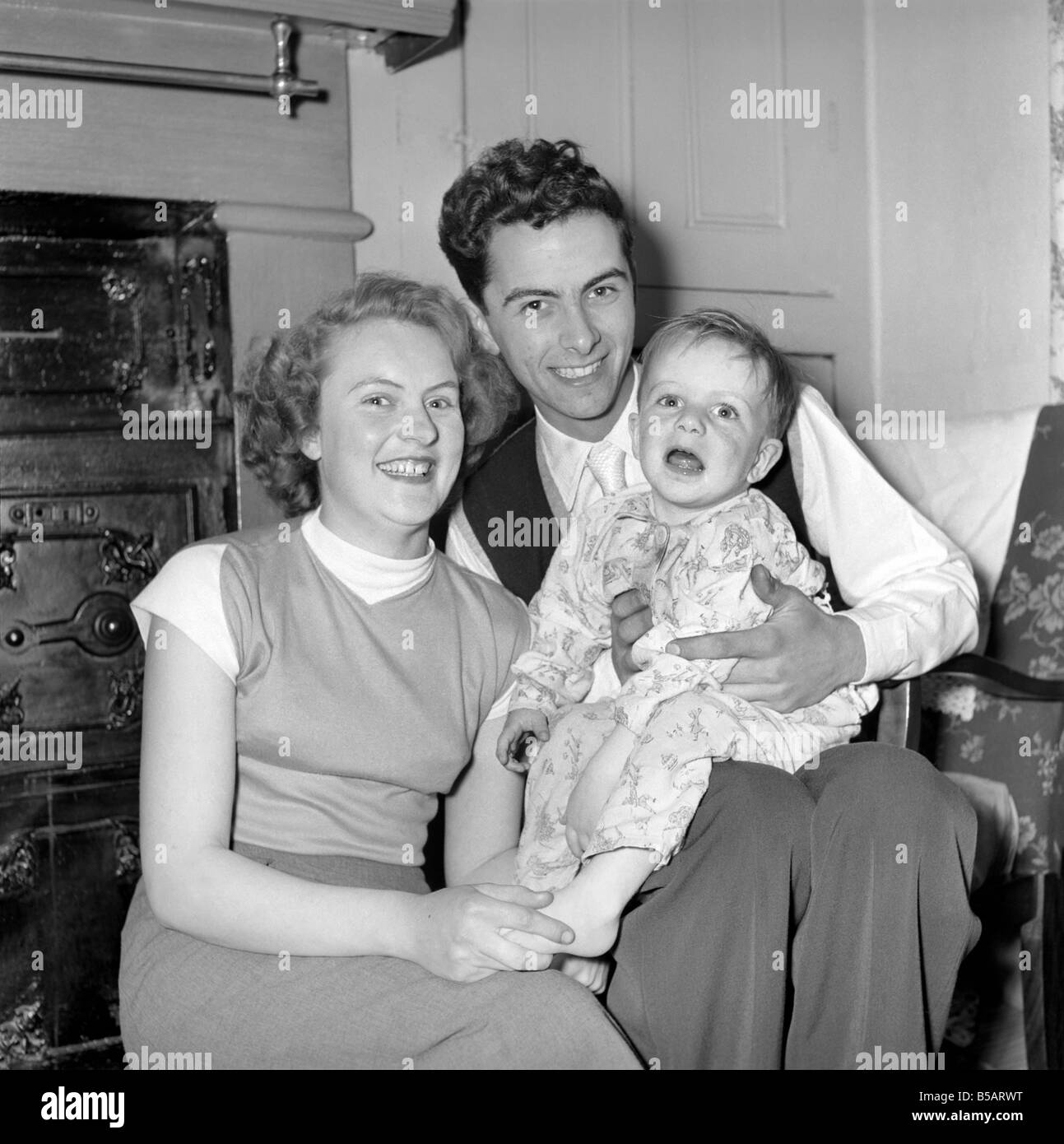 Family life: Mr. and Mrs. Hull with their son before giving him tea. 1954 A160-004 Stock Photo