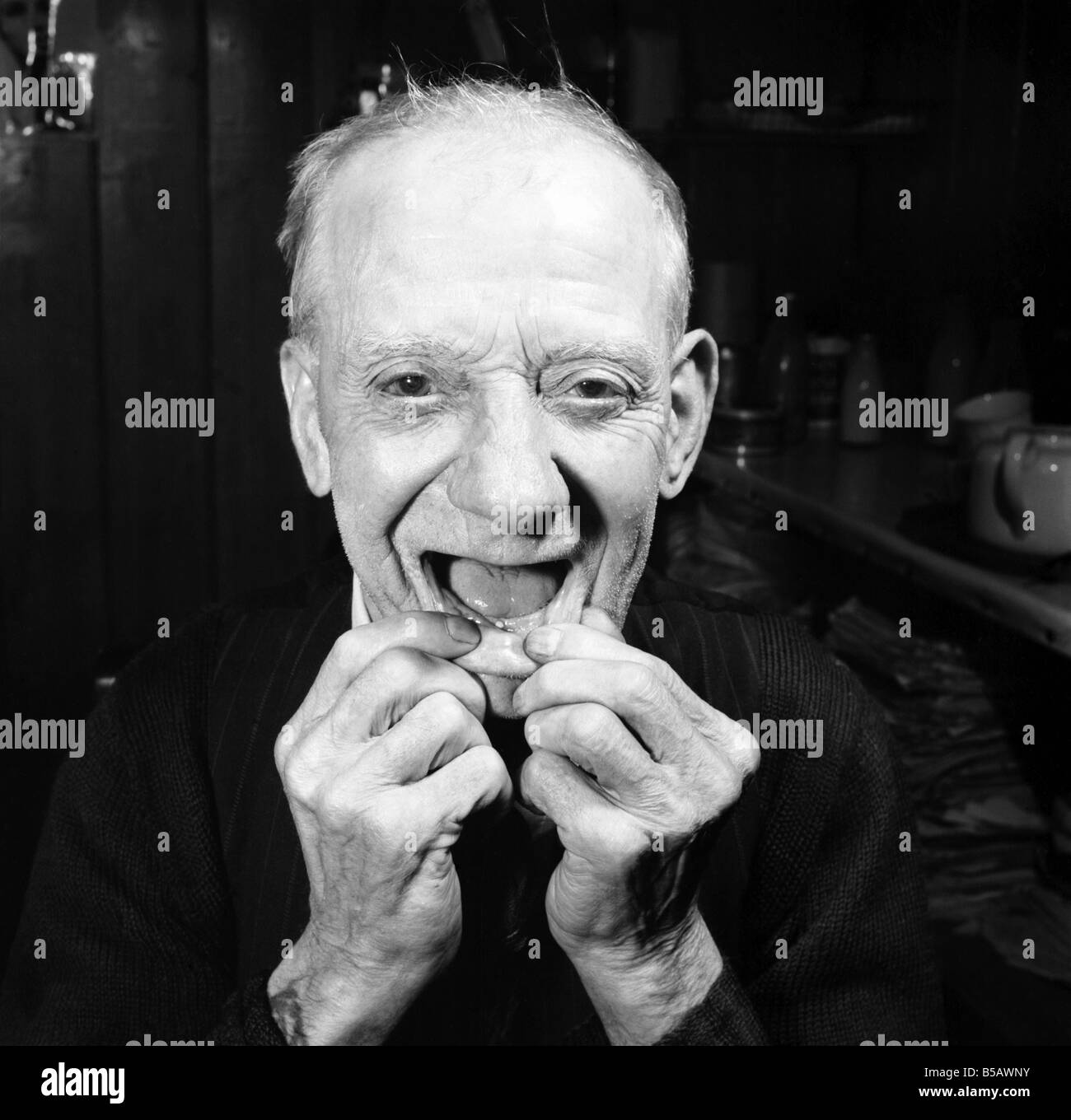 Pensioner with a new tooth. 77 year old man (George Berry) shows off his new tooth. July 1958 A702-006&#13;&#10; Stock Photo
