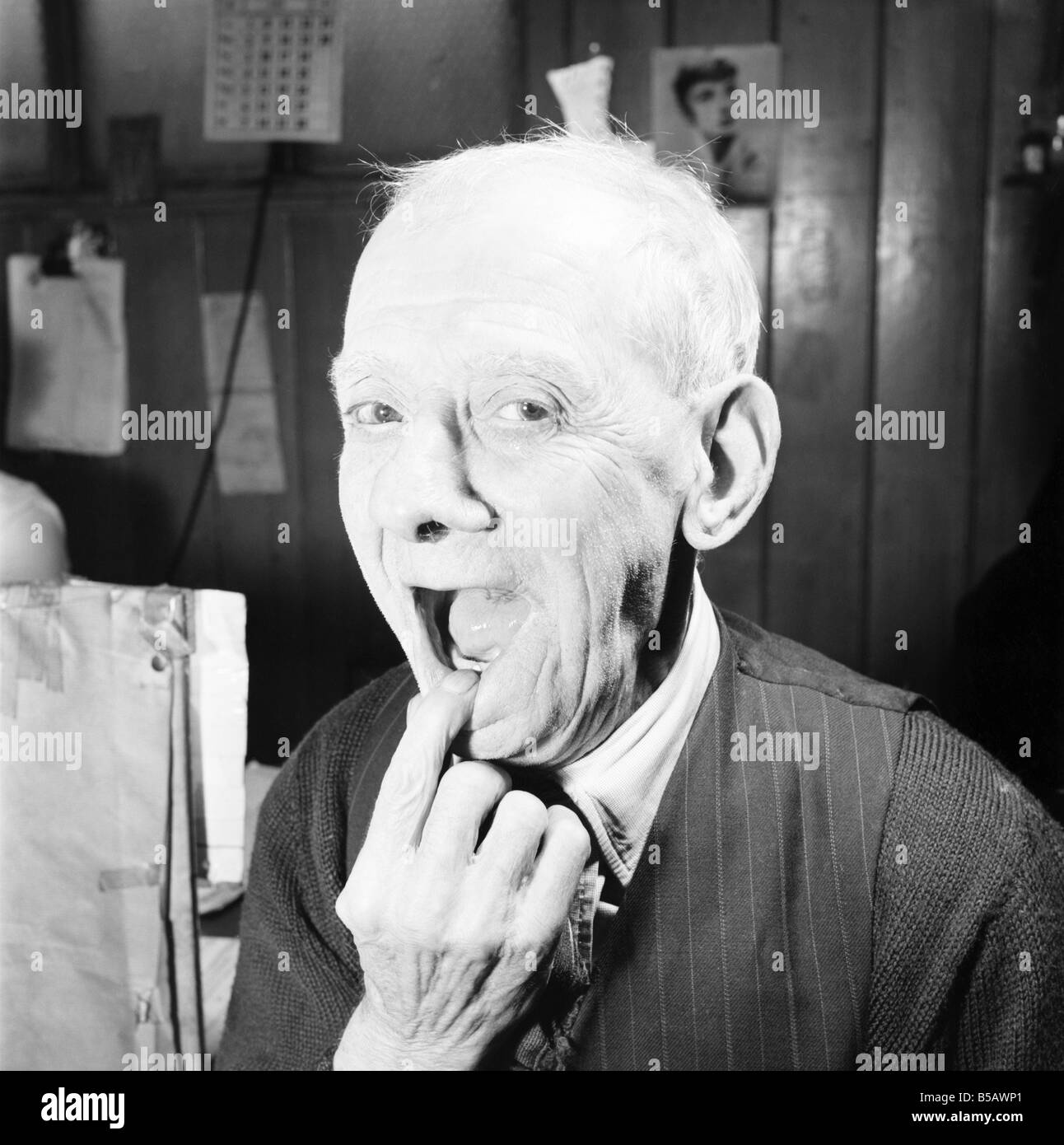 Pensioner with a new tooth. 77 year old man (George Berry) shows off his new tooth. July 1958 A702-007 Stock Photo