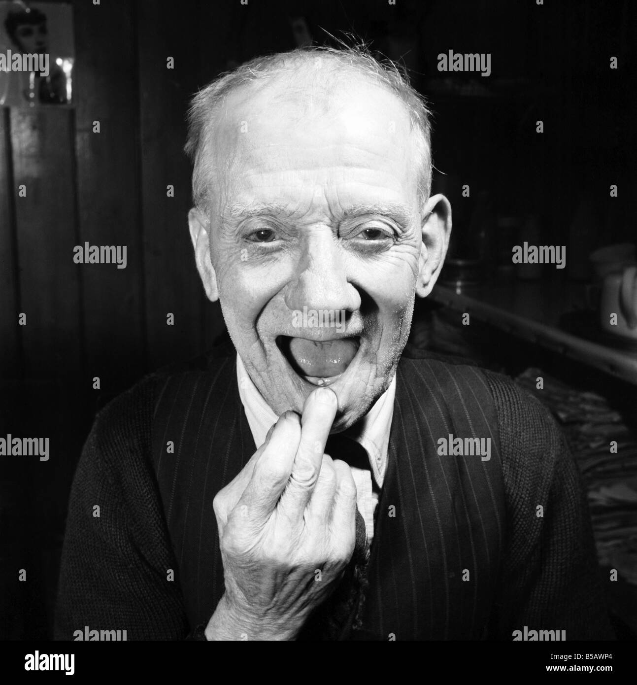 Pensioner with a new tooth. 77 year old man (George Berry) shows off his new tooth. July 1958 A702-008 Stock Photo
