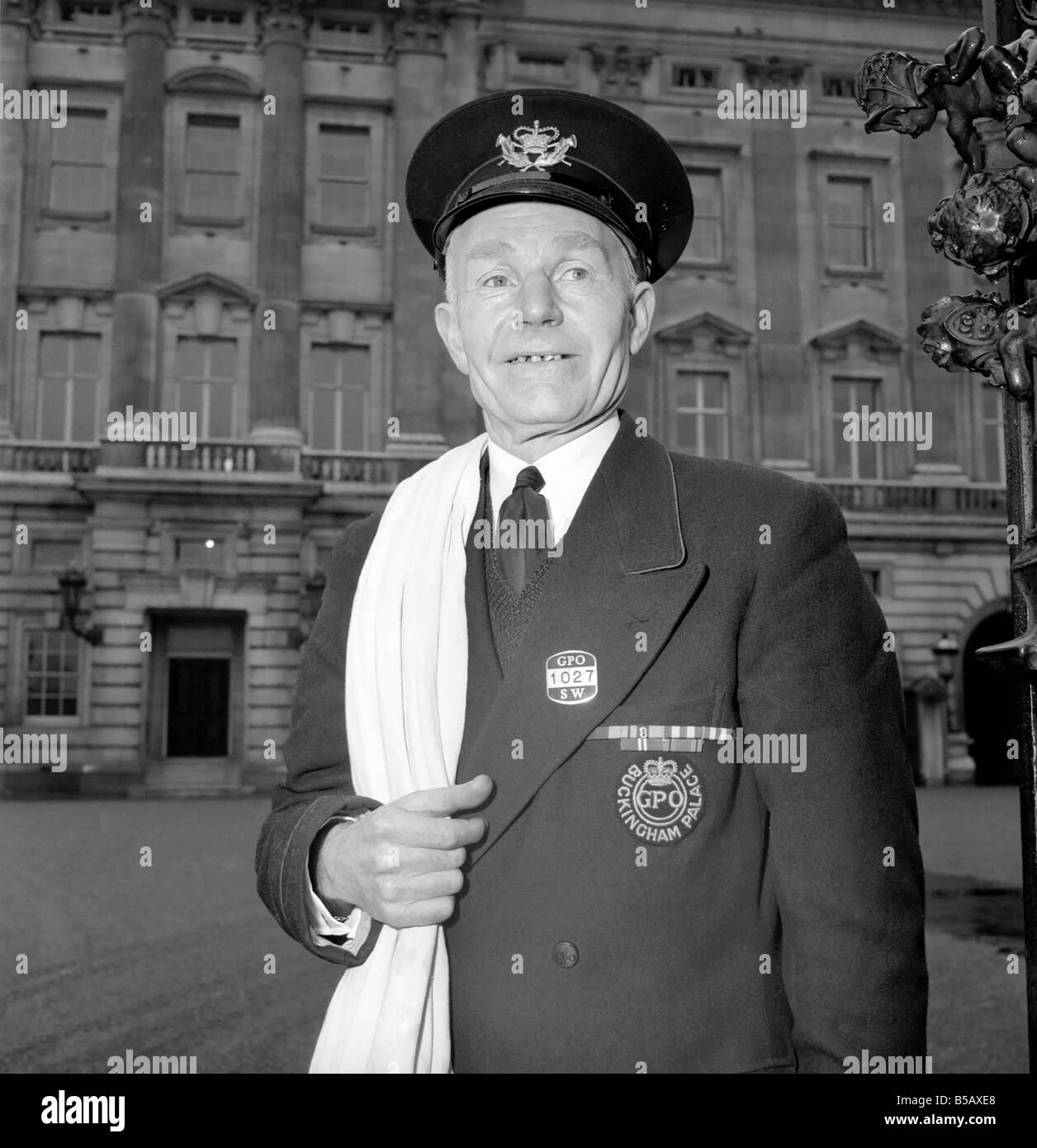 The Royal Postman stands at the gates to Buckingham Palace before collecting Queen ElizabethÍs mail. 1957 A874-002 Stock Photo