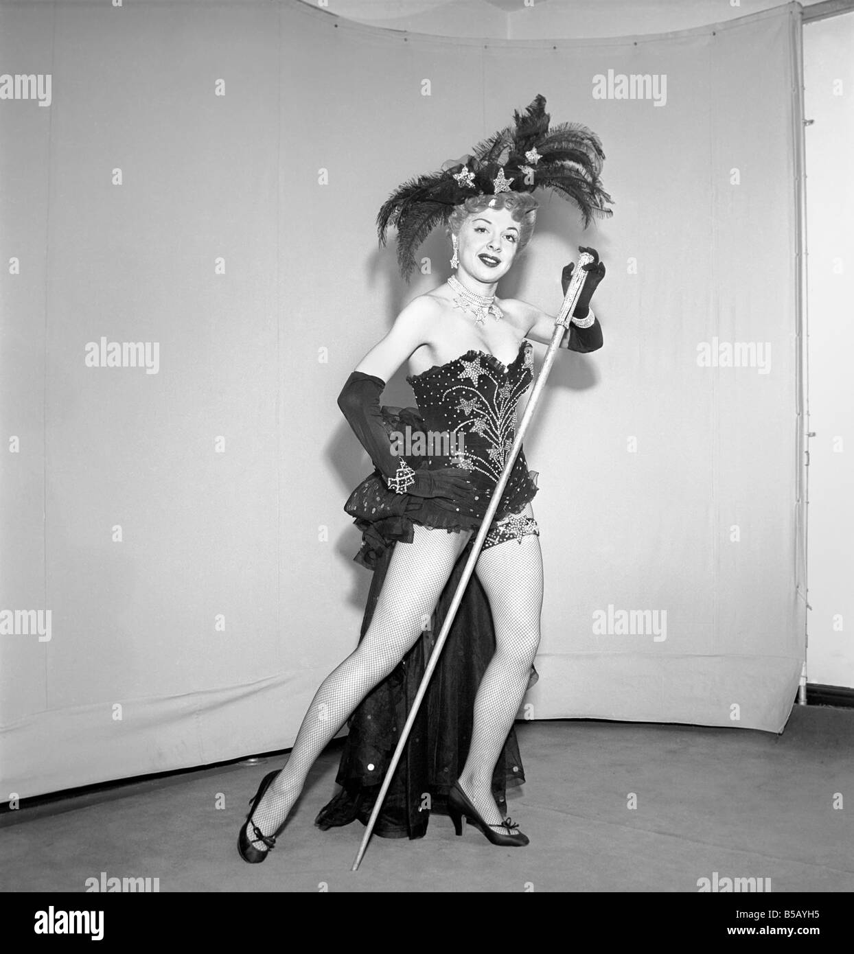 Show girl wearing star spangled costume and cane. Circa 1959 Stock
