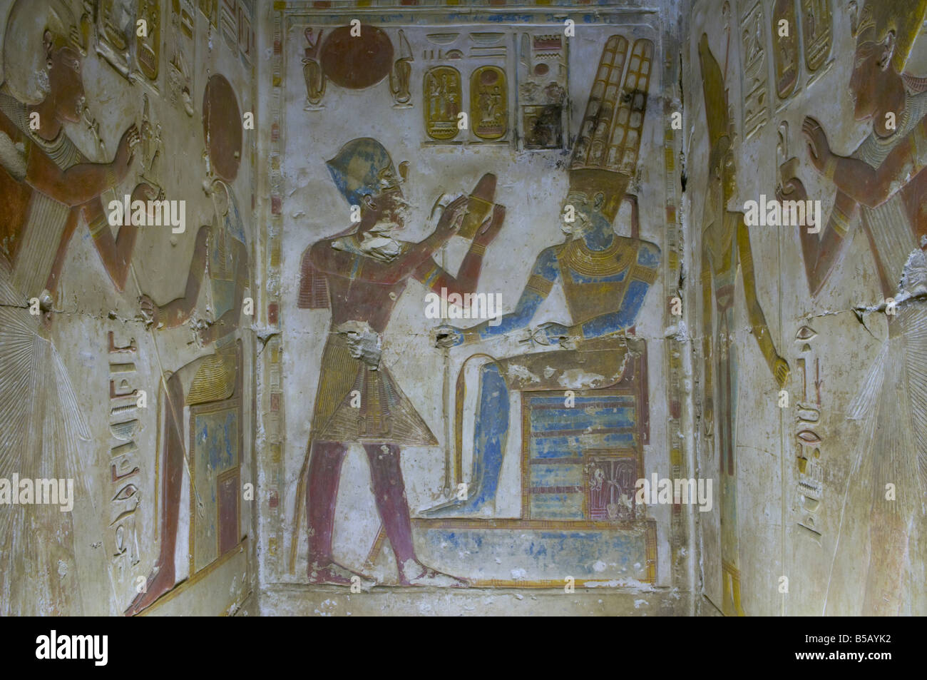 Panel from the Osiris temple: Horus presents royal regalia to a worshiping pharaoh in Abydos one of the oldest cities of ancient Egypt Stock Photo