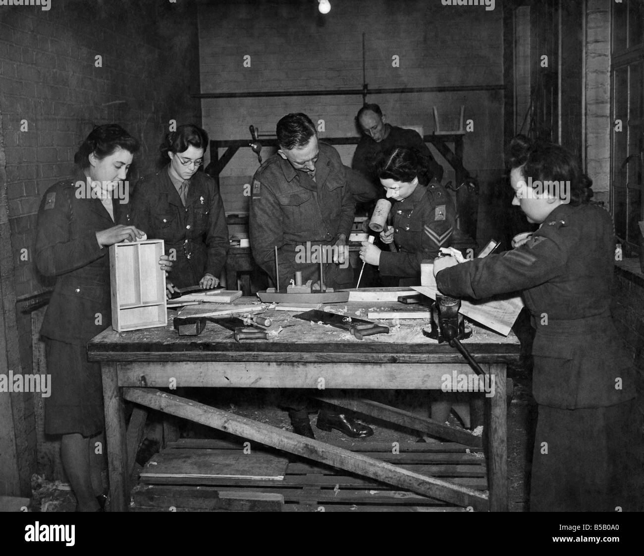 A.T.S. furniture factory. Lt. Archard (Centre) teaching his class the