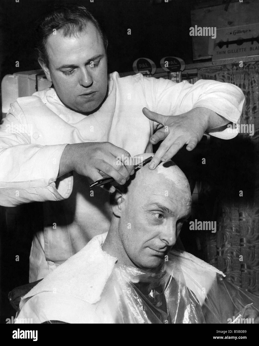 Hair dressers: Barbers: Fred Threlfall has a lather and shave after his hair is cropped by the barber;March 1959 ;P008180 Stock Photo
