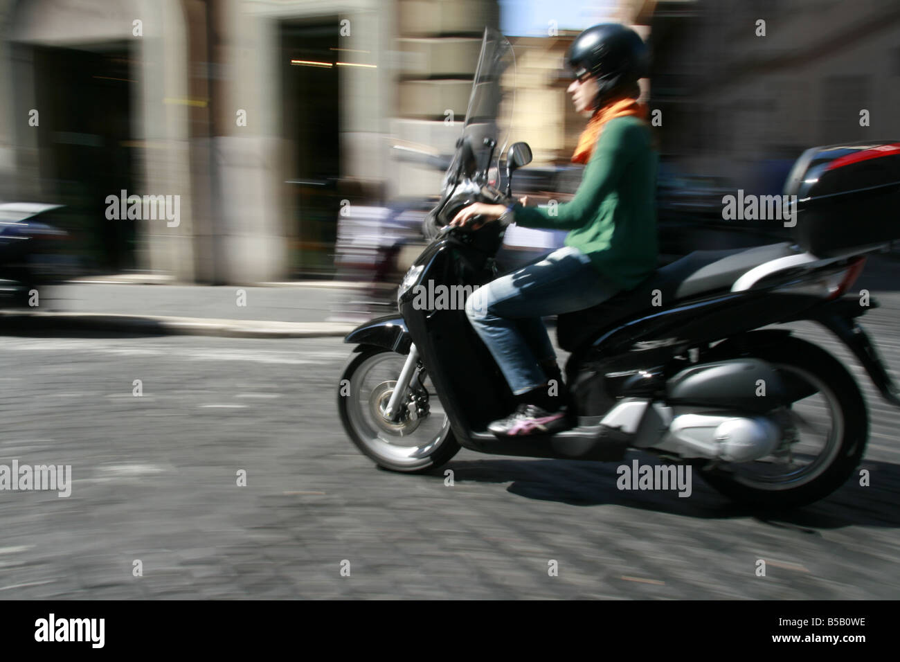 person riding scooter moped in rome italy Stock Photo Alamy