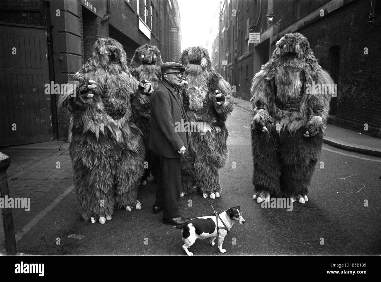 The Yeti Mark two - seven foot tall monsters with light eyes, electrical nervous system, electronic roars, and assisted by a fungoid mist have taken over London for the TV series Dr Who. The yeti's are played by actors Gordon Stothard, John Lord, Colin Warman and John Levene, wearing suits made from Yak fur and wool with eyes that light up.;Our Picture Shows: An anxious moment for a jack russell dog when he meets up with the Yeti's near Goodge Street underground station in London. Dec 1967;X11800 Stock Photo