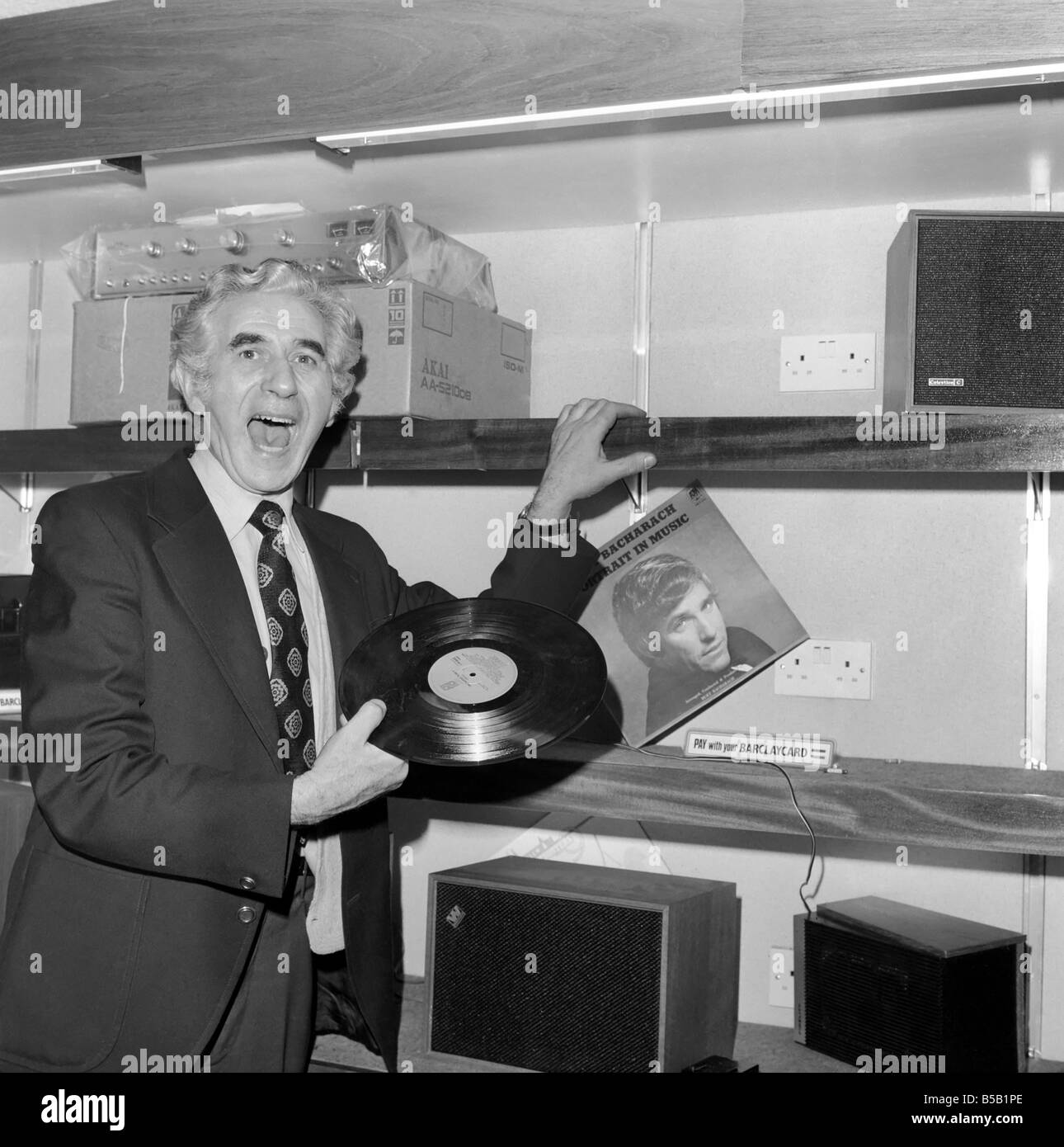 Beat the Budget shopping spree in Tottenham Court Road, London, street of radio and Hi-fi. Man buying records from a store Apr. Stock Photo