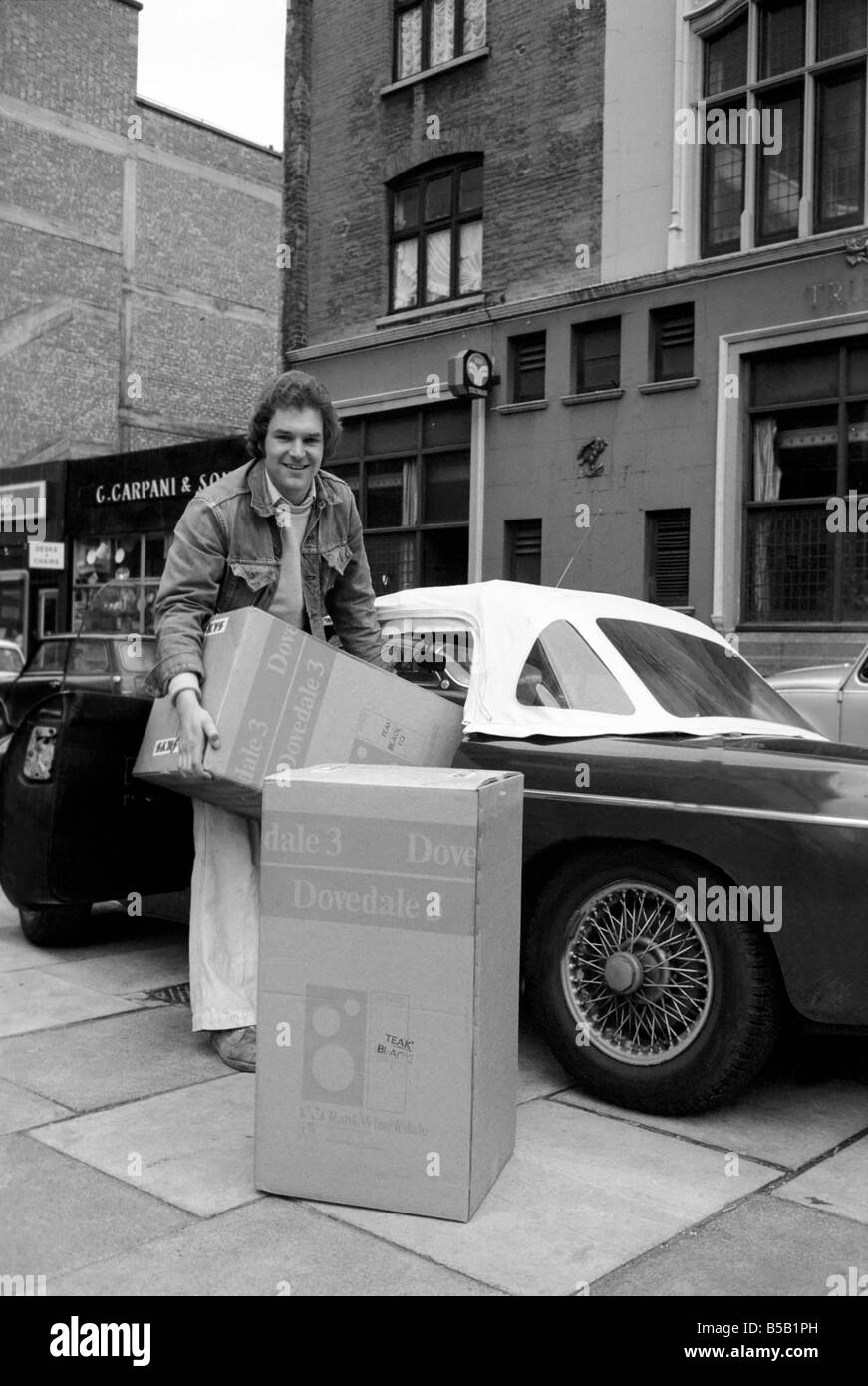 Beat the Budget shopping spree in Tottenham Court Road, London, street of radio and Hi-fi. ;Ken Morton, 23 bought a pair of Hi-fi speakers and is helped with one of them to the car, by one of LaskyÕs staff. April 1975 ; Stock Photo