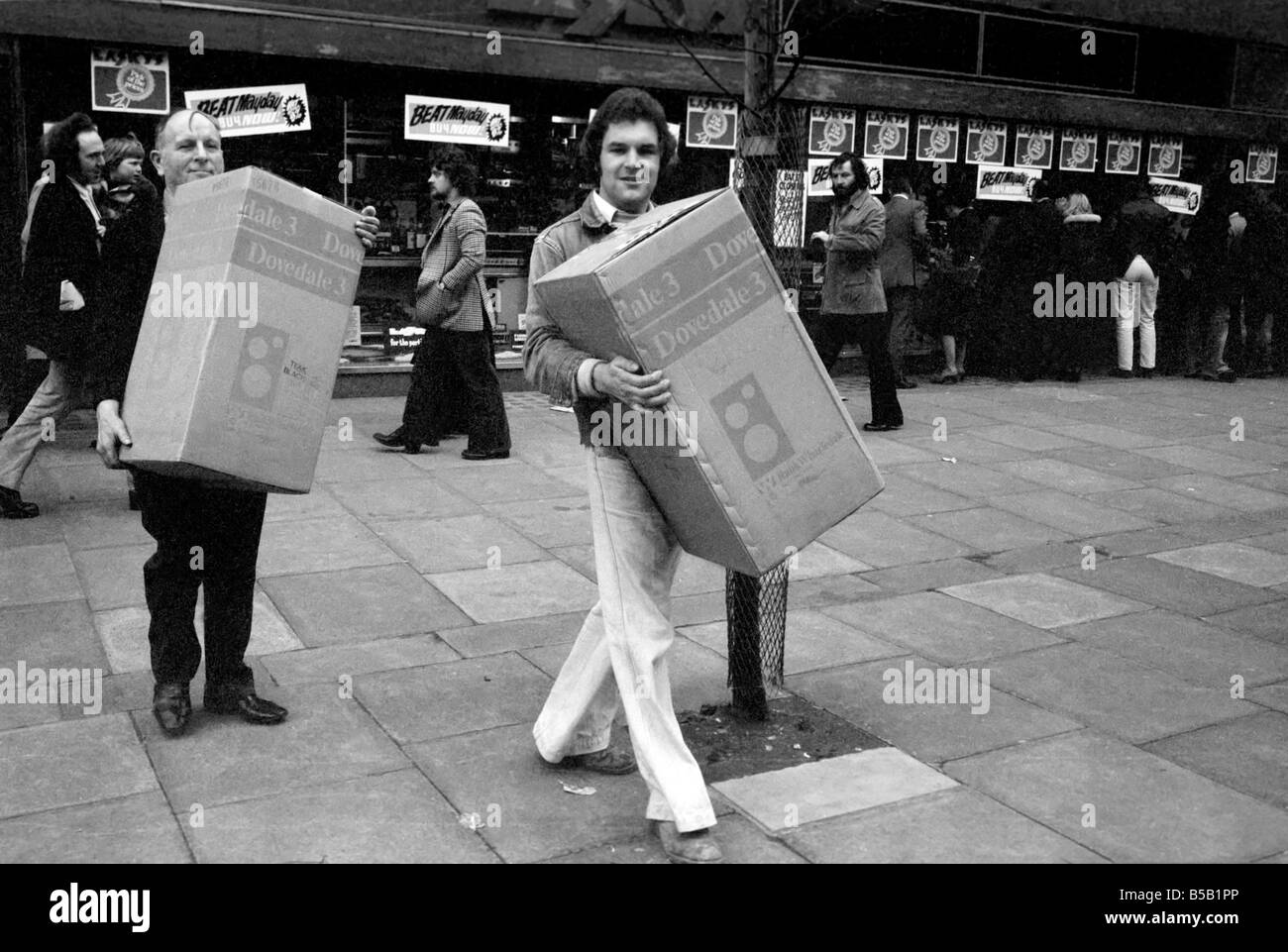 Beat the Budget shopping spree in Tottenham Court Road, London, street of radio and Hi-fi. ;Ken Morton, 23 bought a pair of Hi-fi speakers and is helped with one of them to the car, by one of LaskyÕs staff. April 1975 ; Stock Photo
