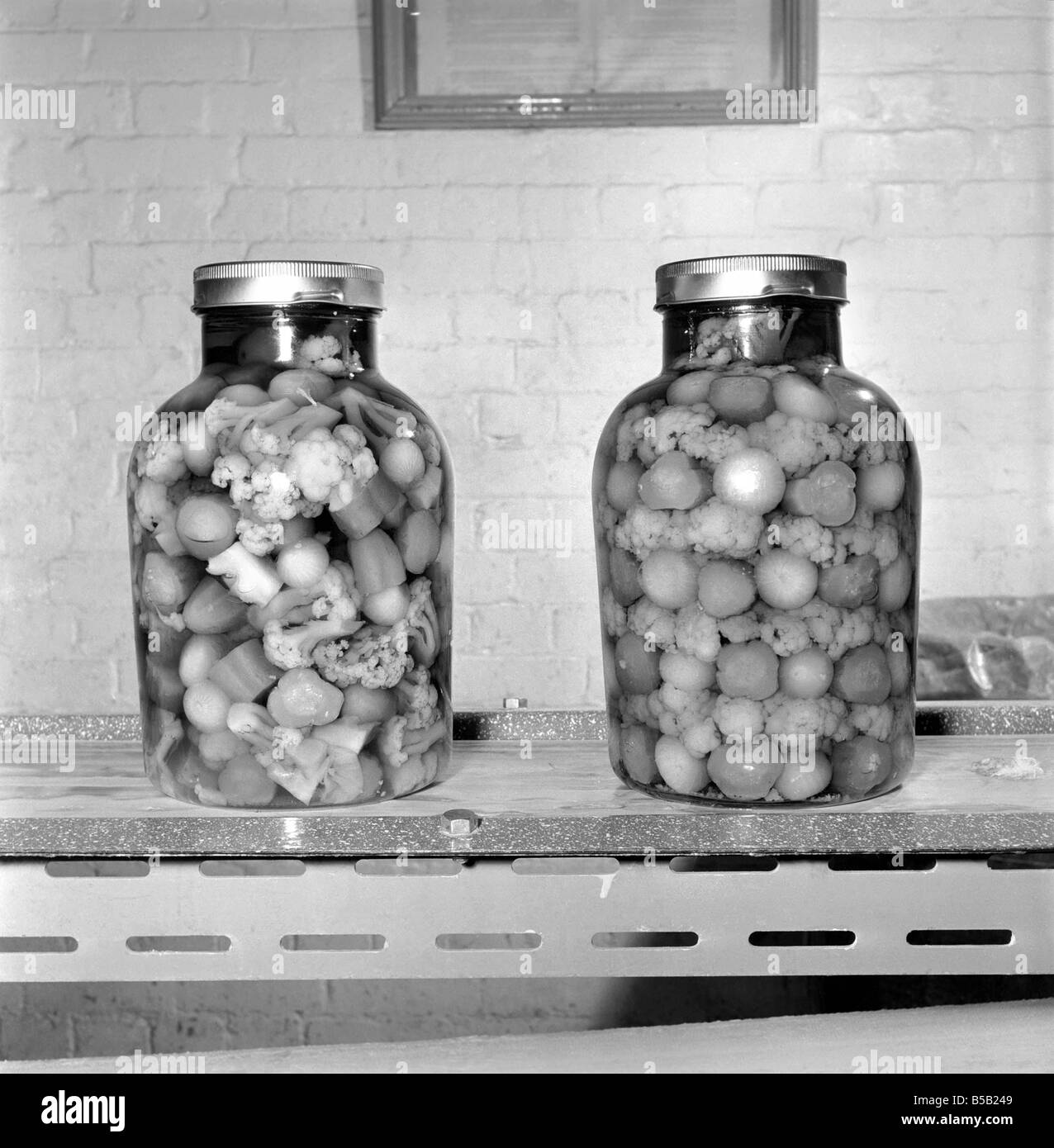 Pickle Packers: Jars of pickle onions and vegtables. 1954 Stock Photo