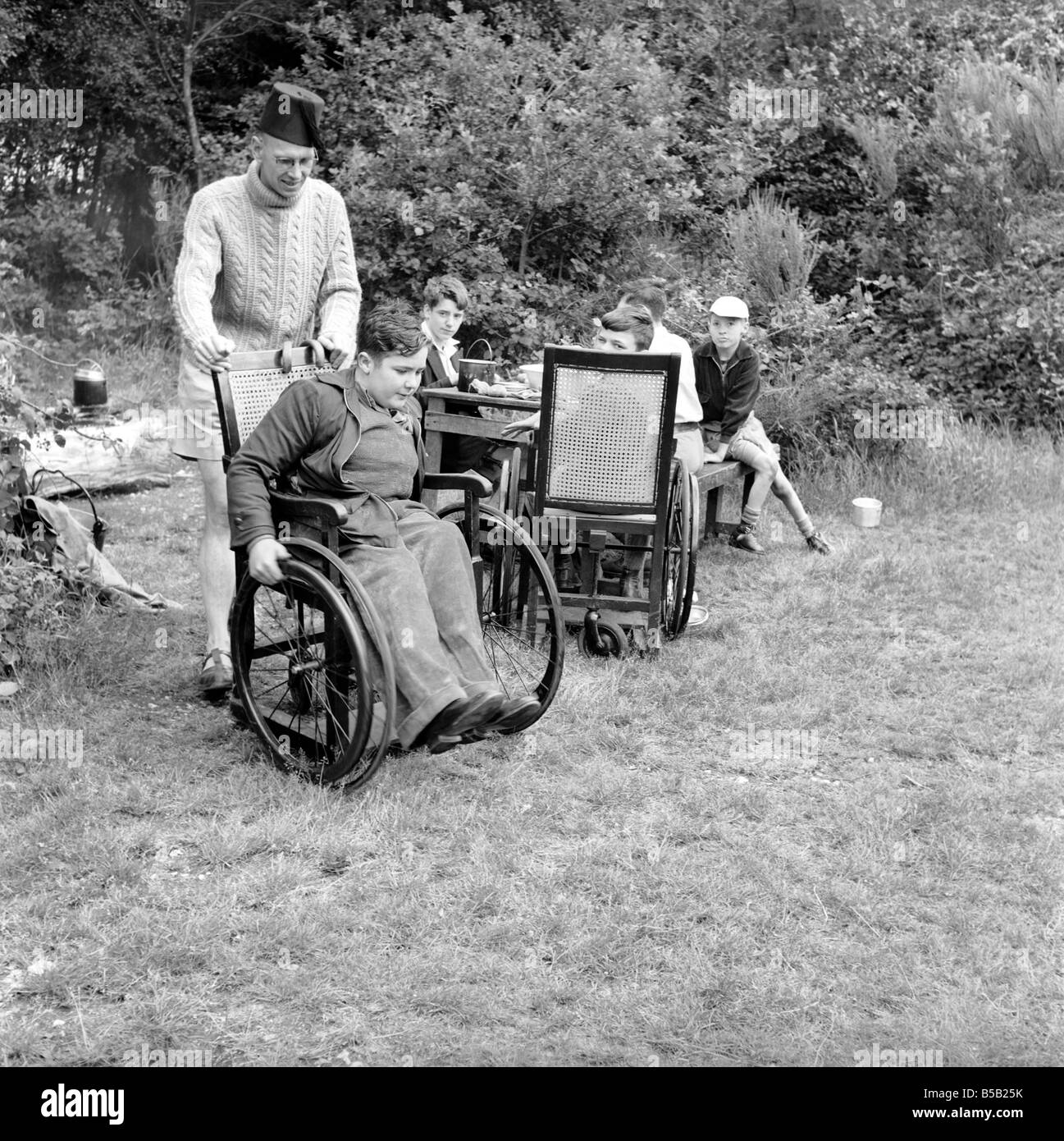 Disability and Youth: Tommy Hoare the legless boy scout seen here enjoying camping. July 1955 Stock Photo
