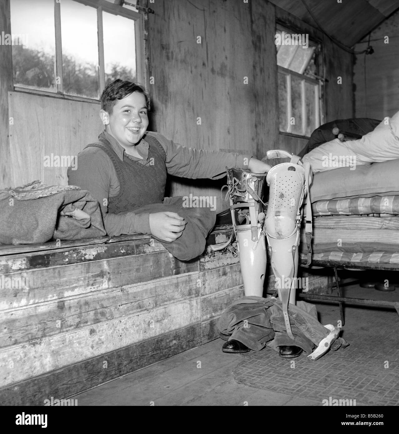 Disability and Youth: Tommy Hoare the legless boy scout seen here enjoying camping. July 1955 Stock Photo