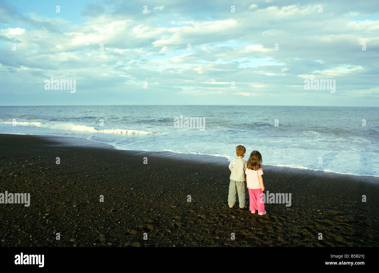 Two young children, boy and girl, on the beach at Napier, North Island, New Zealand, Pacific Stock Photo