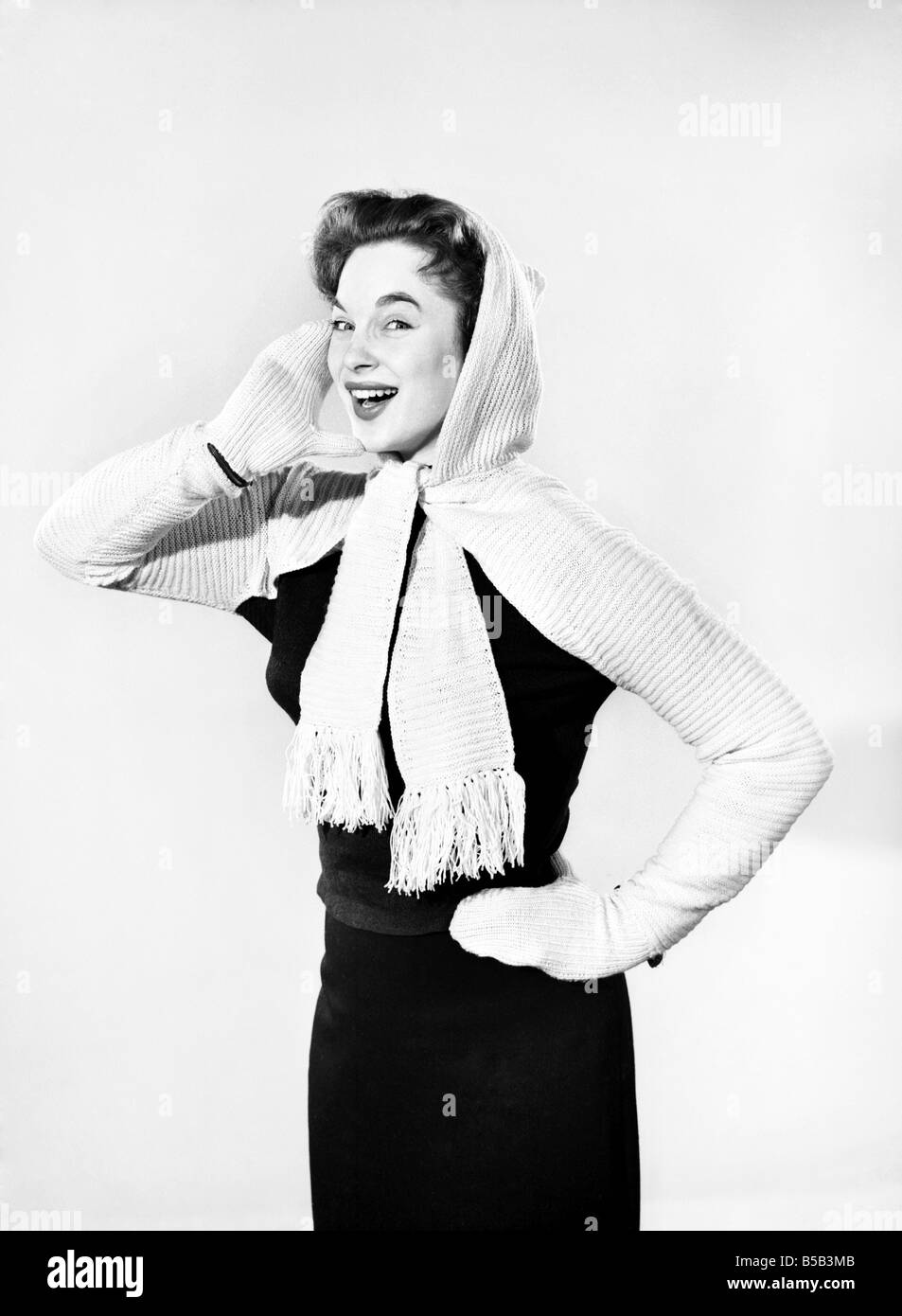 Model wearing combined hooded scarf and gloves. 1955 Stock Photo - Alamy