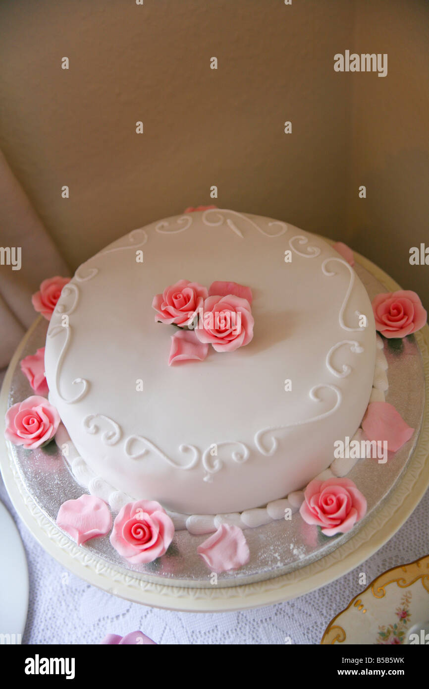 A wedding cake with icing roses Stock Photo Alamy