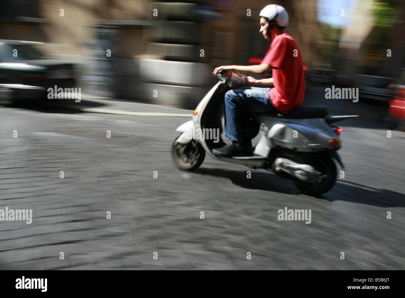 person riding scooter moped in rome italy Stock Photo Alamy
