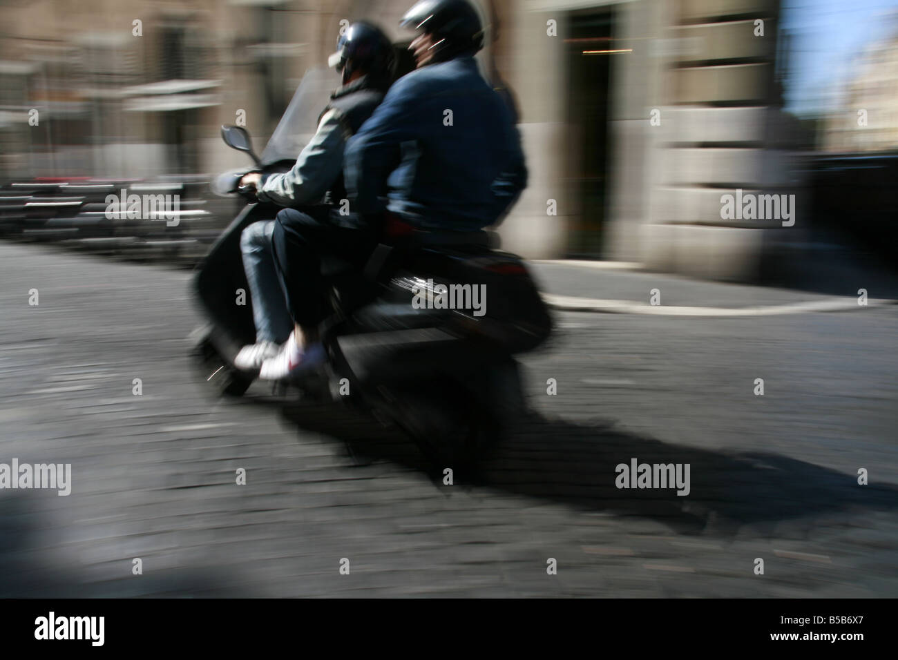 two people riding scooter moped in rome italy Stock Photo Alamy