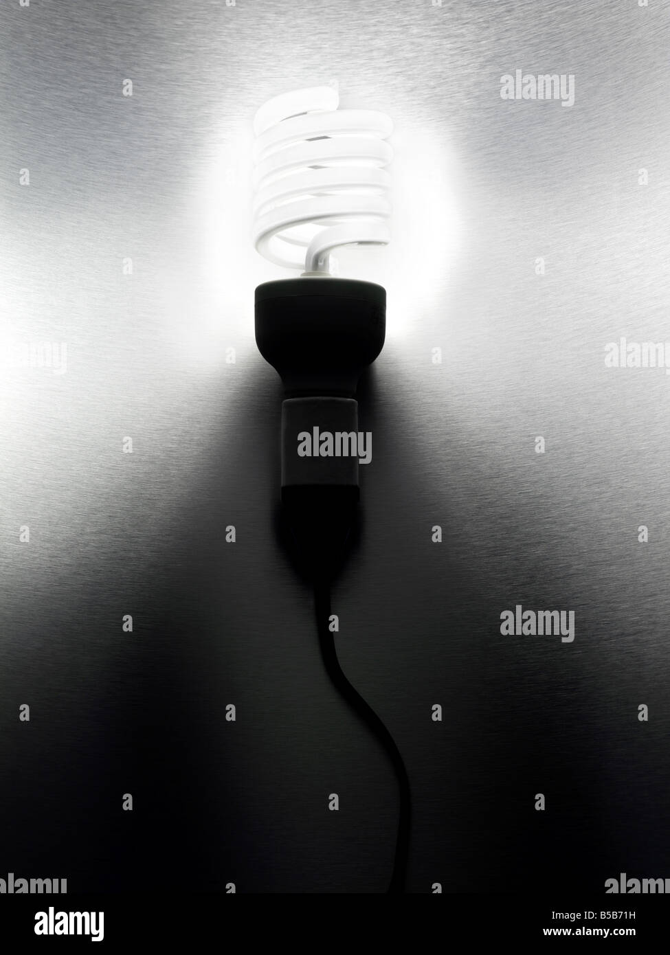 fluorescent spiral ecofriendly light bulb on a stainless steel