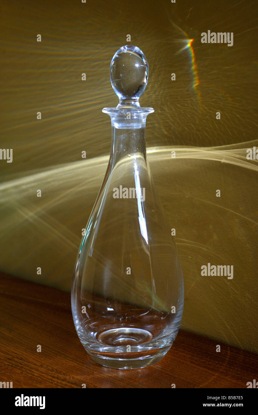 Glass decanter in sunlight and shadow. Stock Photo