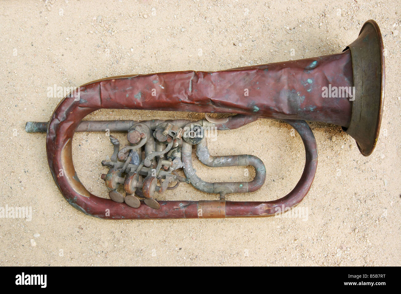 Shot of the old and broken trumpet on the sand Stock Photo Alamy