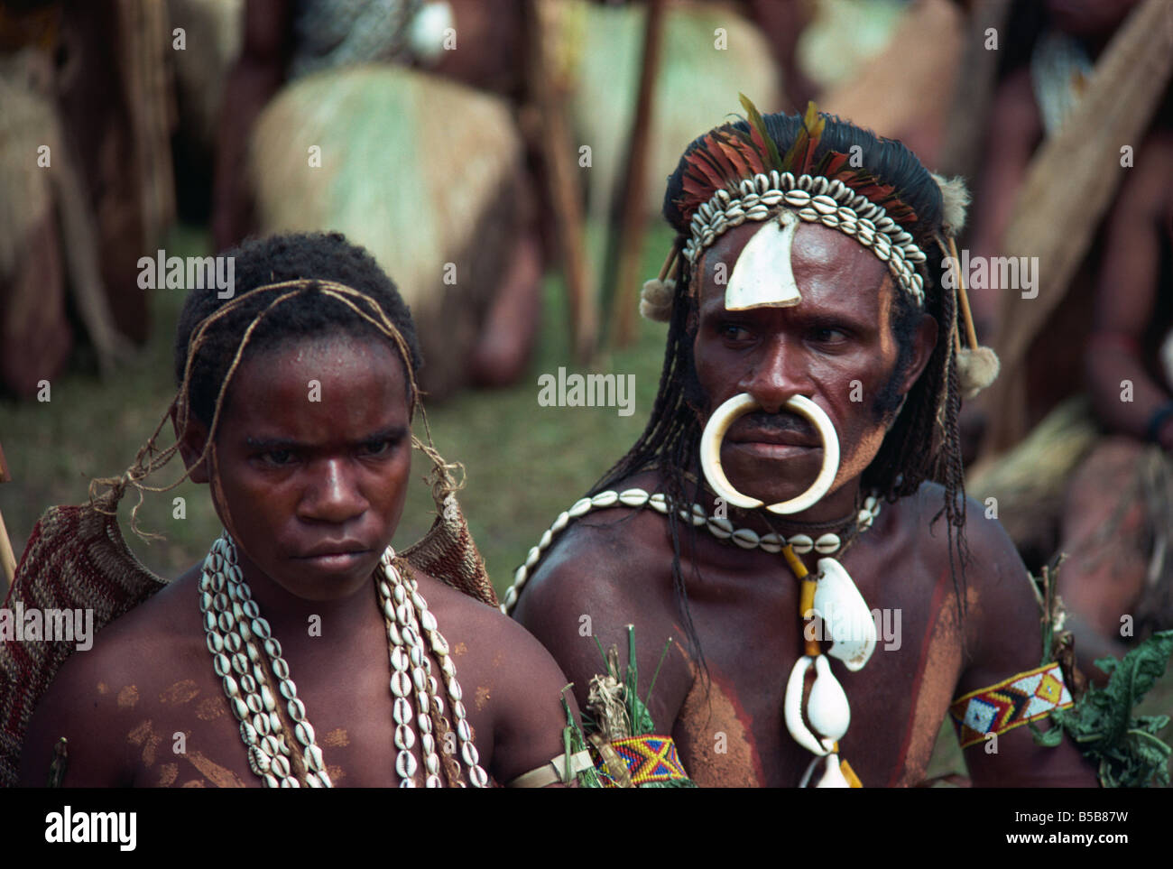 Portrait of a man and wife with bone and cowry shell jewellery and decoration at a Sing sing in Papua New Guinea Pacific Stock Photo