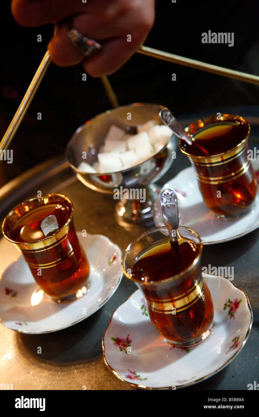 Hand holding a tray with Turkish tea, Istanbul, Turkey, Europe Stock Photo
