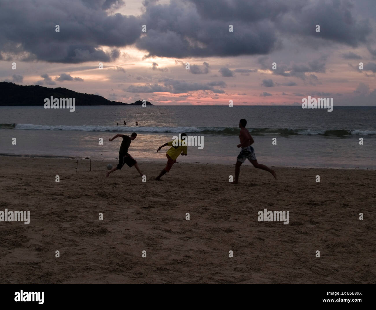 sunset football action on the beach in Phuket Thailand Stock Photo