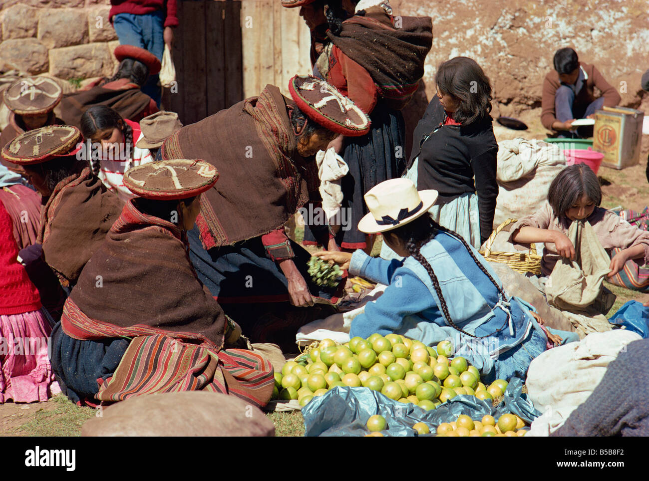 Groups of women selling fruit at the Sunday market at Chincheros in the ...