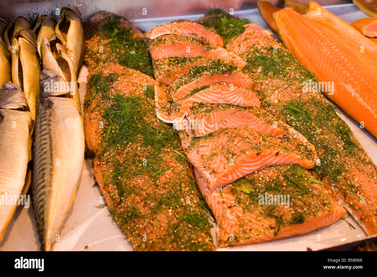 Smoked salmon with dill and herbs, and other smoked fish for sale at the Bergen Fish Market in Bergen Norway Stock Photo