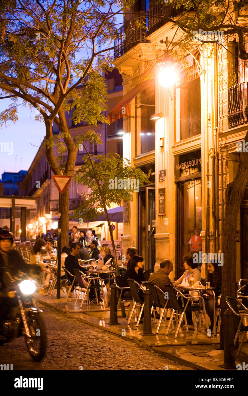 People sitting outside a cafe bar on Plaza Tossal in the historic El Carmen city centre of Valencia Spain Stock Photo