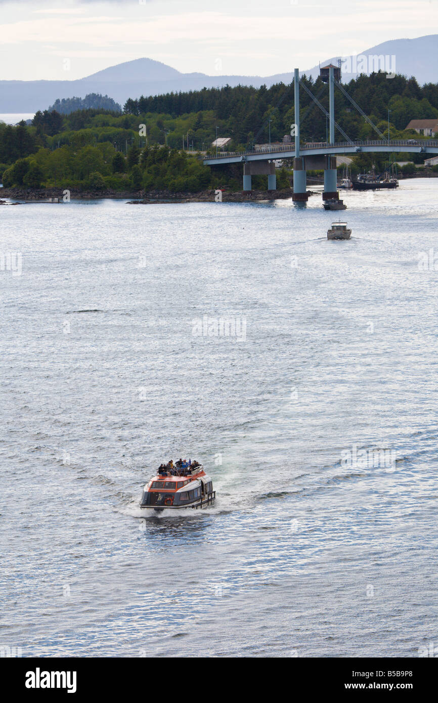 Tender boat carries passengers from shore to cruise ship in the Eastern Channel at Sitka, Alaska Stock Photo