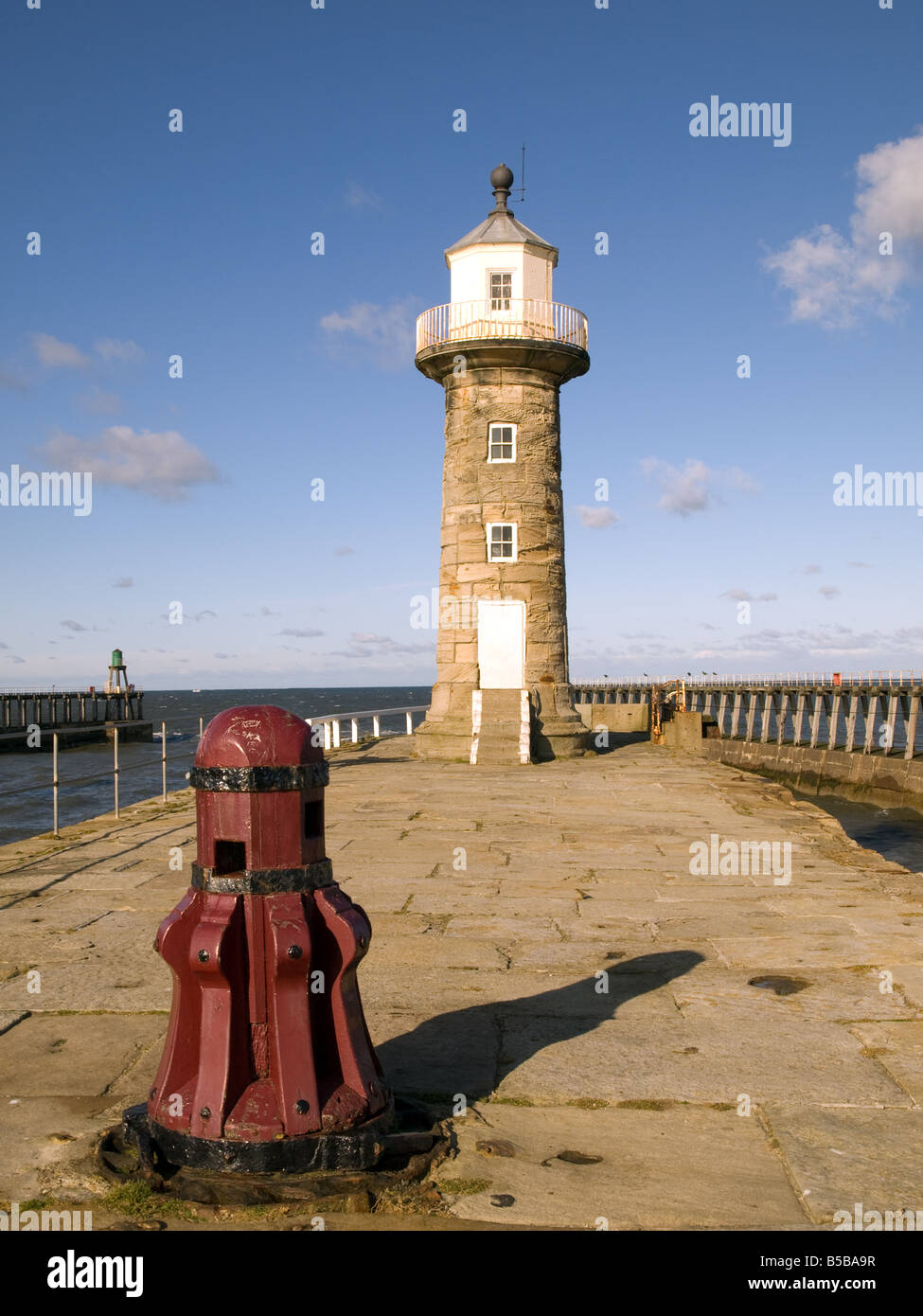 Whitby East Pier Lighthouse and Capstan Stock Photo Alamy