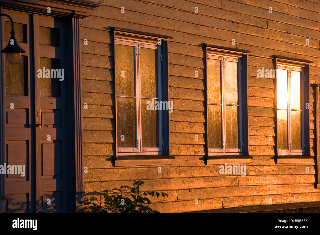 The late day summer sun casts its light on some windows in the old town of Gamlebyen in Fredrikstad Norway, south of Oslo Stock Photo