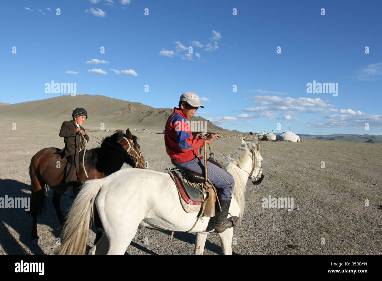 Mongolian boys on a horses Stock Photo - Alamy