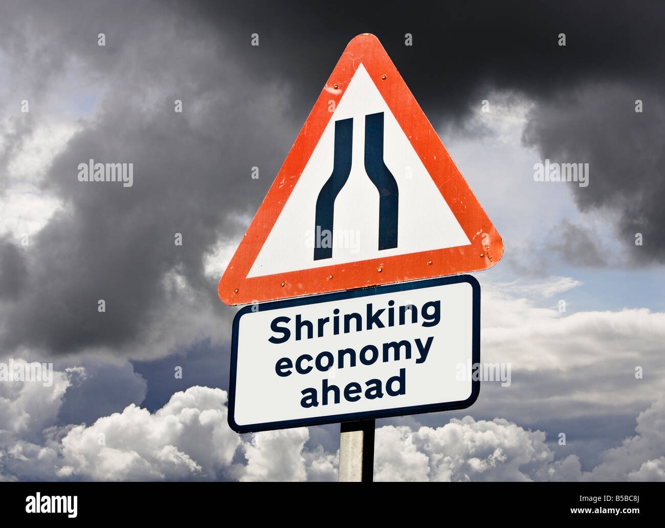 Shrinking economy - productivity / debt / output / low growth concept sign UK against a stormy sky Stock Photo
