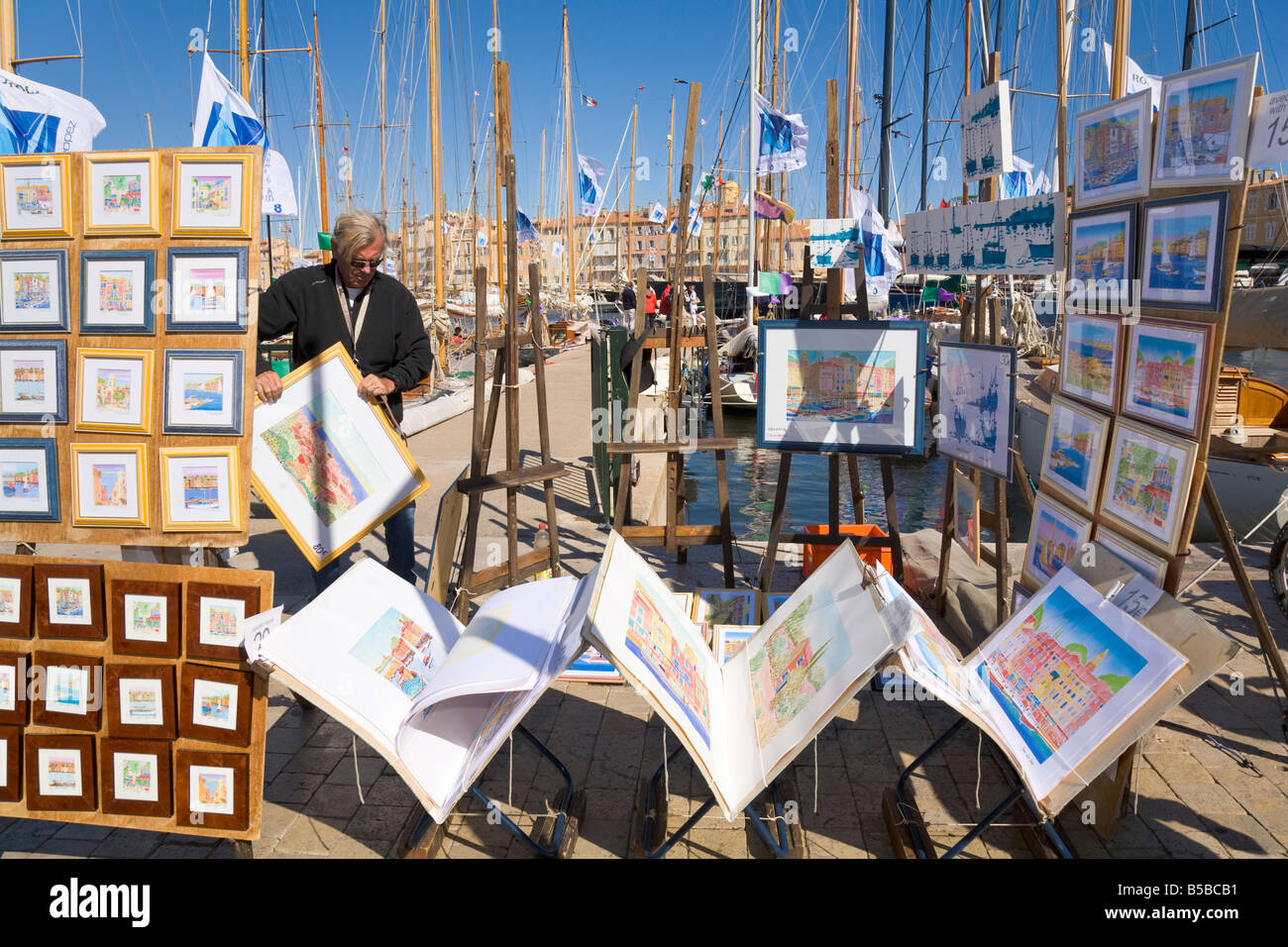 Watercolour paintings are displayed for sale at the port of Saint-Tropez at the Cote d'Azur / Provence / Southern France Stock Photo