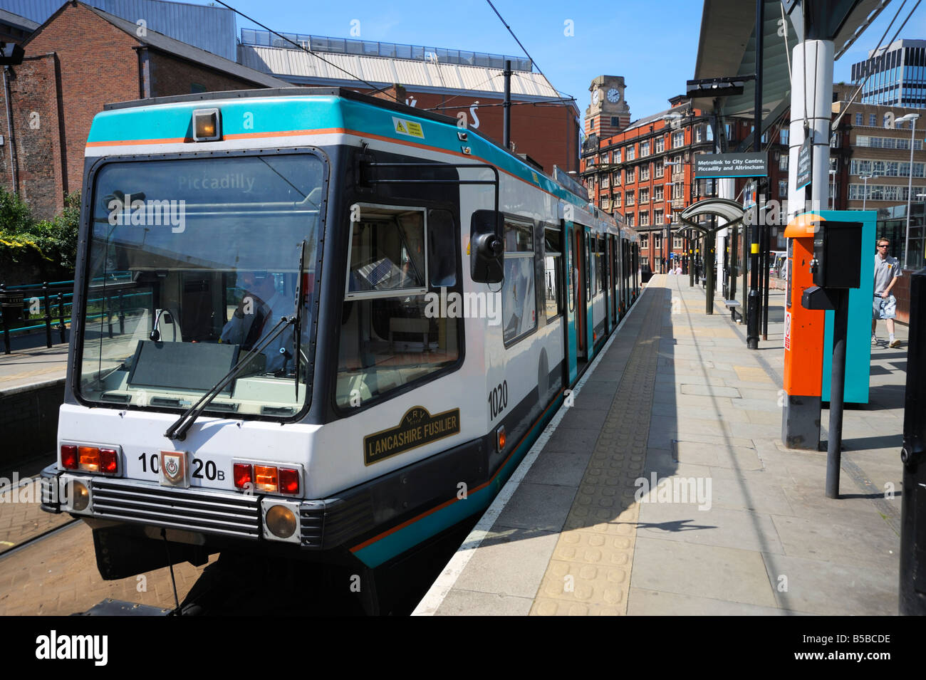 Metrolink tram at tram stop, Manchester, England, Europe Stock Photo
