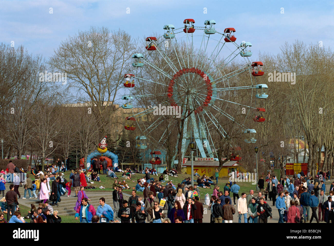 Crowds at a funfair with a big wheel during Earth Day Festival in Gorky Park in Moscow Russia G Hellier Stock Photo
