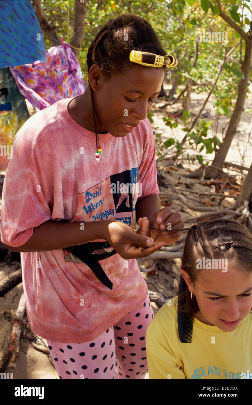 Women braiding young girl s hair Mayreau Island the Grenadines Windward Islands West Indies Caribbean Central America Stock Photo